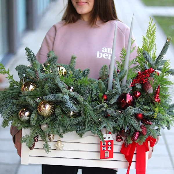Christmas arrangement in a flowerpot with candles and glass balls